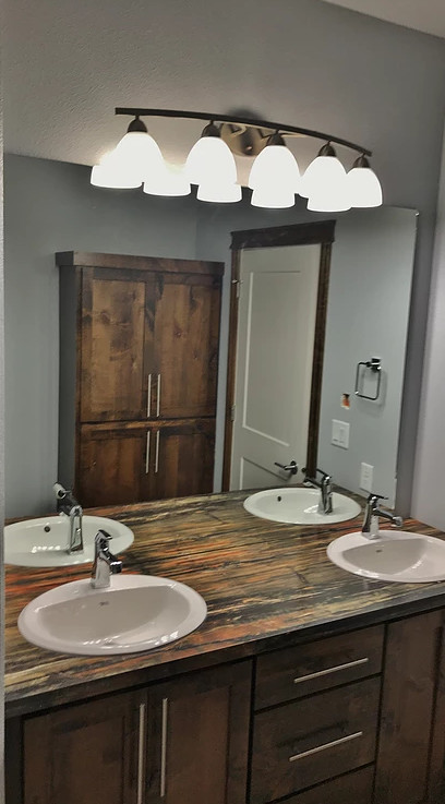 Example of a transitional bathroom design with laminate countertops and brown countertops