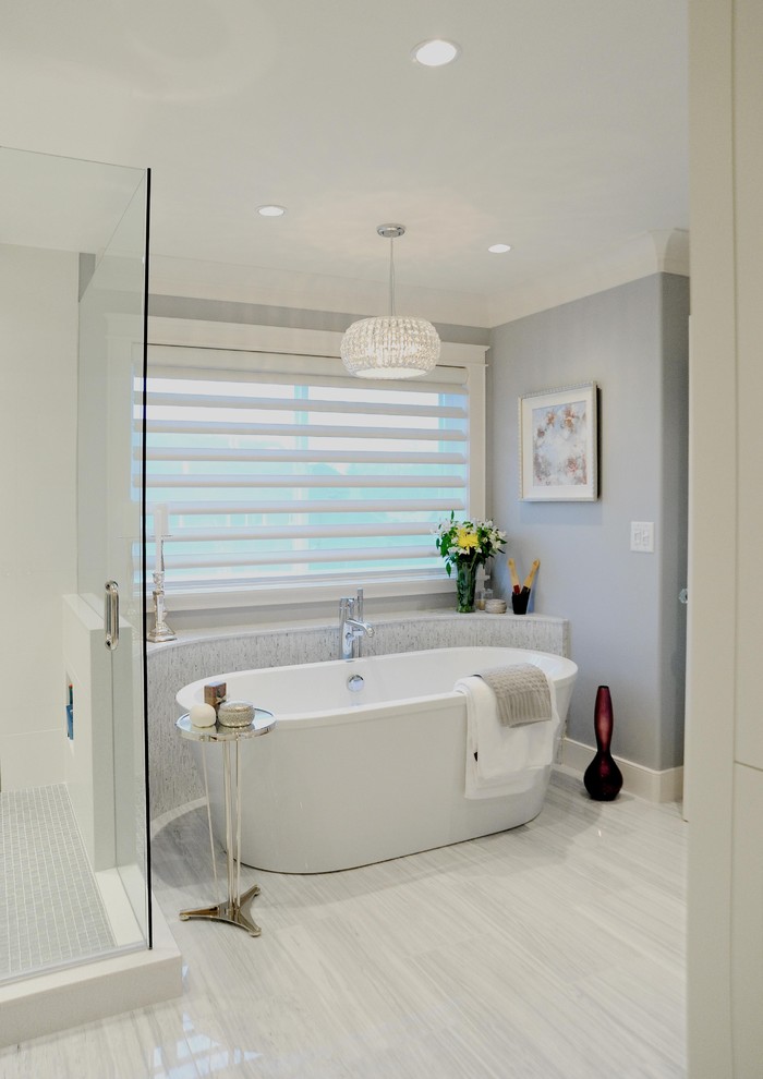 Inspiration for a mid-sized traditional master bathroom in Vancouver with a freestanding tub, a corner shower, white tile, stone tile, marble floors and an undermount sink.