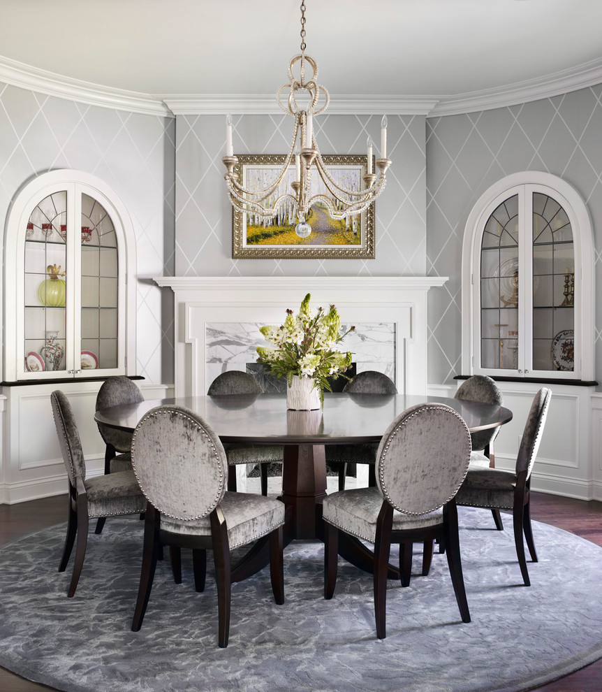 Inspiration for a traditional dining room in Chicago with grey walls, dark hardwood floors, a stone fireplace surround and a standard fireplace.
