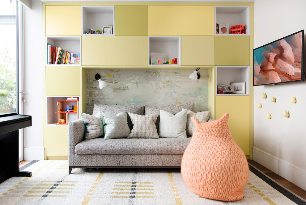 Mid-sized contemporary kids' room in London with white walls, medium hardwood floors, brown floor and wallpaper.