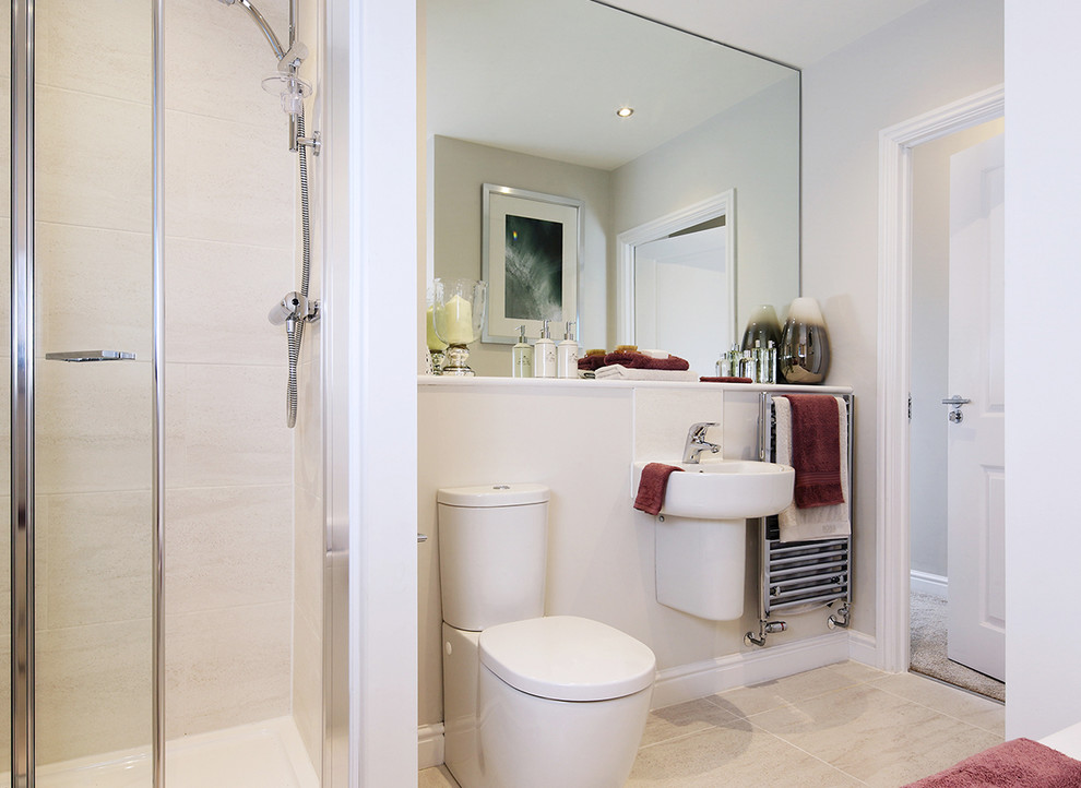 Small modern kids bathroom in Cheshire with a corner tub, a corner shower, a two-piece toilet, beige tile, white walls, porcelain floors, a wall-mount sink, beige floor and a hinged shower door.