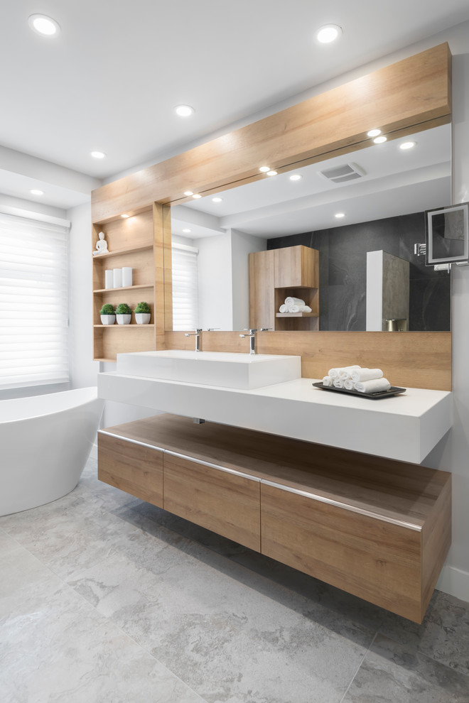Design ideas for a mid-sized contemporary master bathroom in Montreal with flat-panel cabinets, beige cabinets, a freestanding tub, an alcove shower, a two-piece toilet, black tile, ceramic tile, beige walls, ceramic floors, a vessel sink, engineered quartz benchtops, beige floor, an open shower and white benchtops.