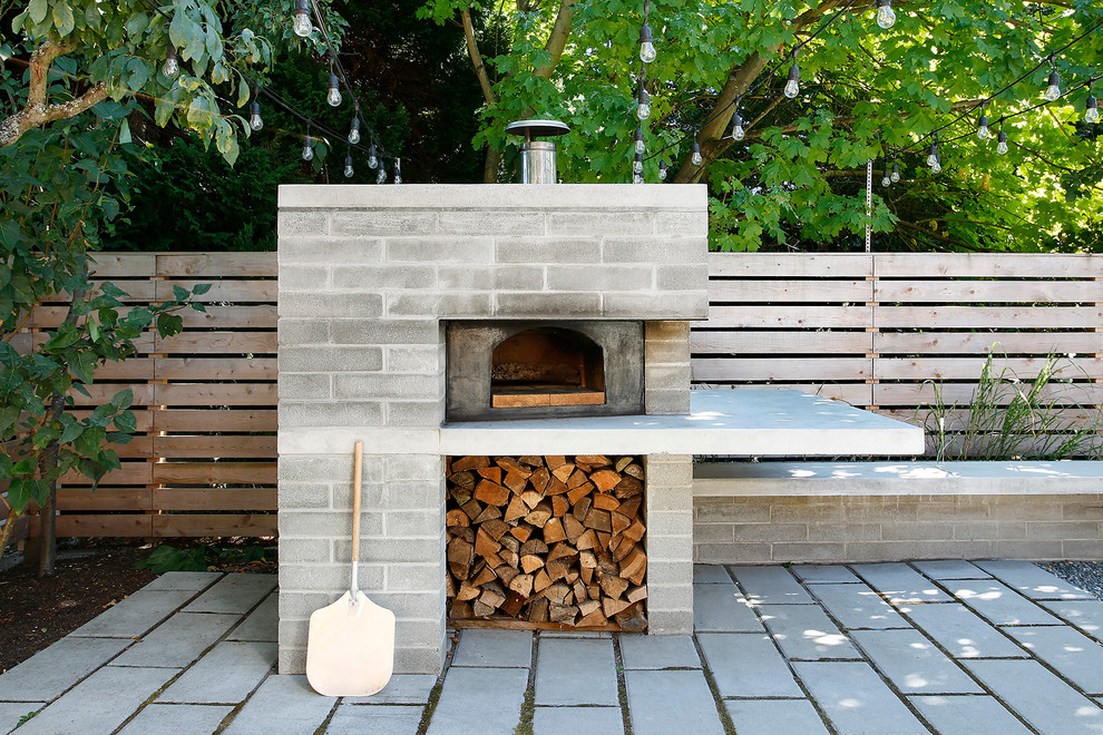 Mid-sized trendy backyard concrete paver patio photo in Seattle with a fire pit and no cover
