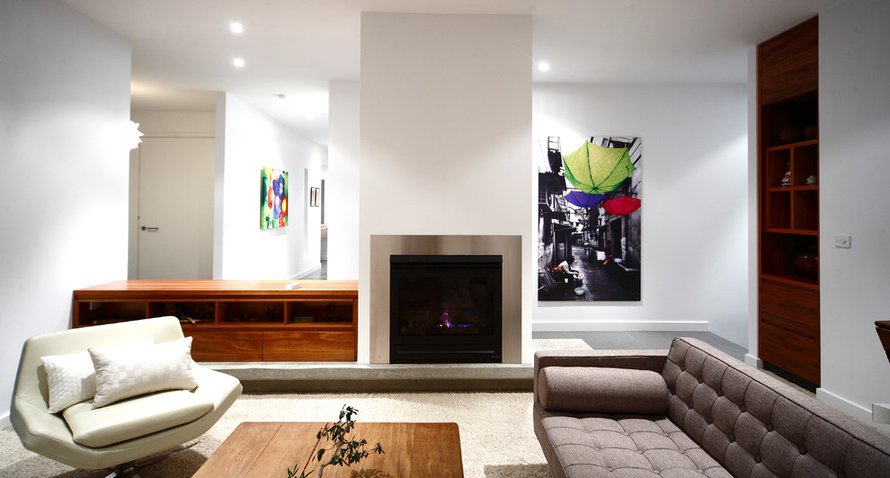 Design ideas for a mid-sized midcentury enclosed living room in Canberra - Queanbeyan with white walls, ceramic floors, a standard fireplace and a metal fireplace surround.