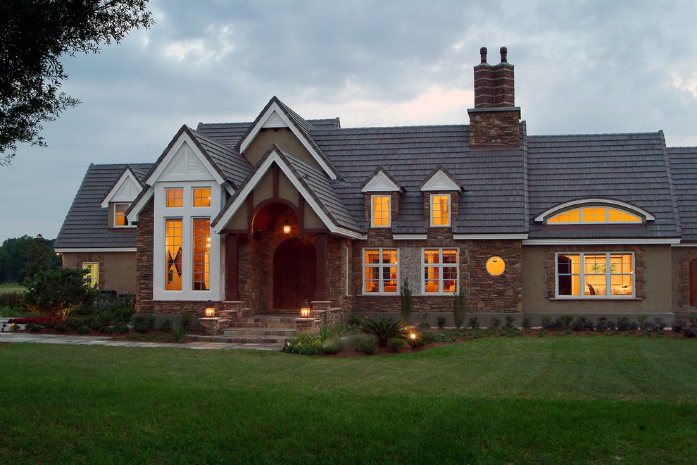 Inspiration for a large arts and crafts one-storey stucco brown exterior in Orlando with a gable roof.
