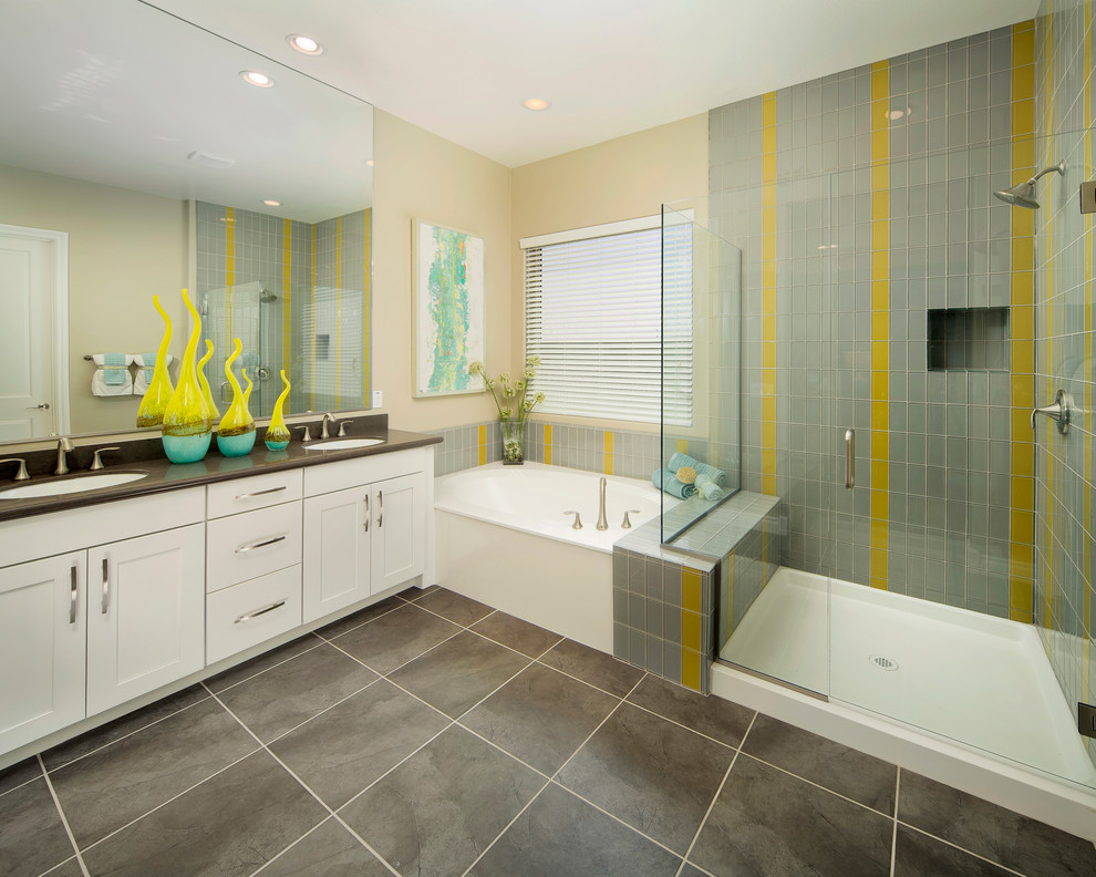 This is an example of a transitional bathroom in Phoenix with an undermount sink, shaker cabinets, white cabinets, a corner shower, gray tile and glass tile.