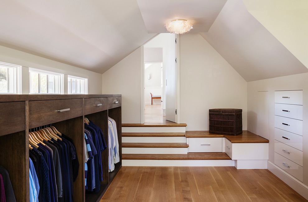 Design ideas for a transitional gender-neutral storage and wardrobe in San Francisco with dark wood cabinets, medium hardwood floors and open cabinets.