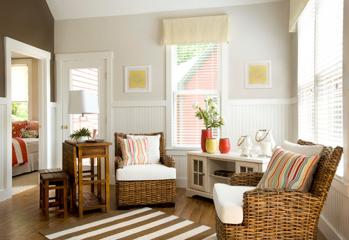 Rattan chairs on brown and white strip rug with white side board