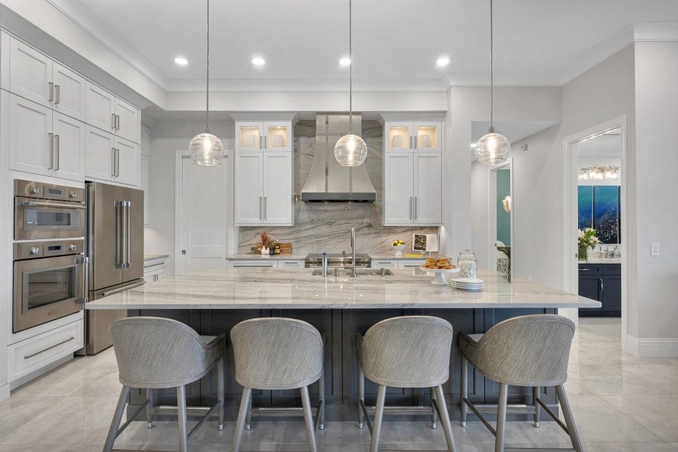 Inspiration for a transitional u-shaped gray floor open concept kitchen remodel in Miami with an undermount sink, shaker cabinets, white cabinets, marble countertops, multicolored backsplash, marble backsplash, stainless steel appliances, an island and multicolored countertops