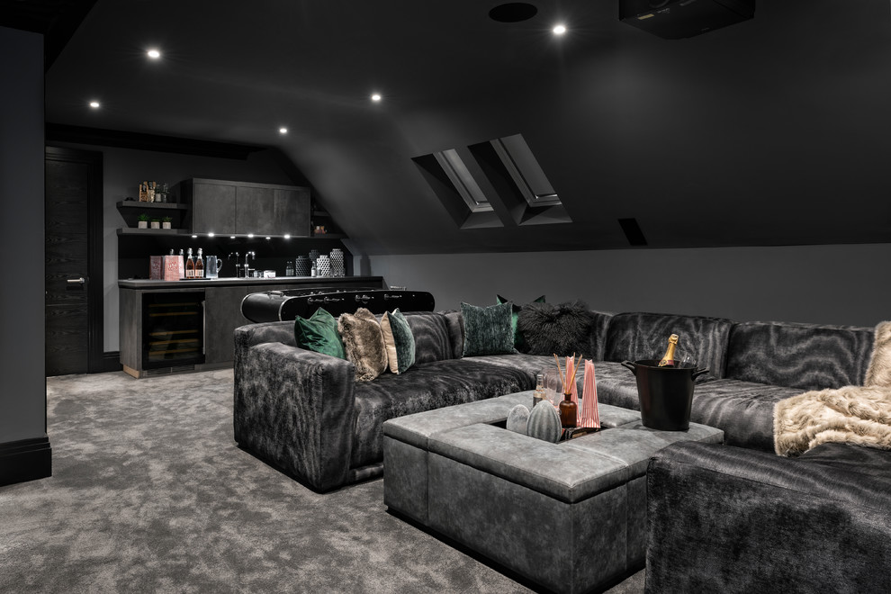 This is an example of a large contemporary home theatre in Buckinghamshire with black walls, carpet and grey floor.