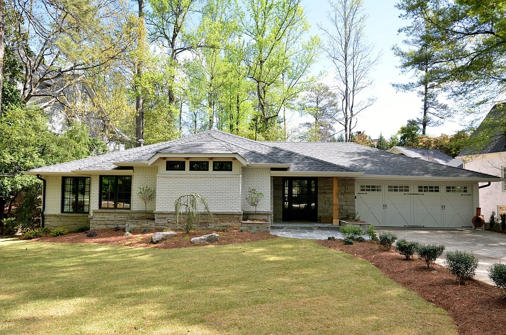 This is an example of a midcentury one-storey exterior in Atlanta with mixed siding and a hip roof.
