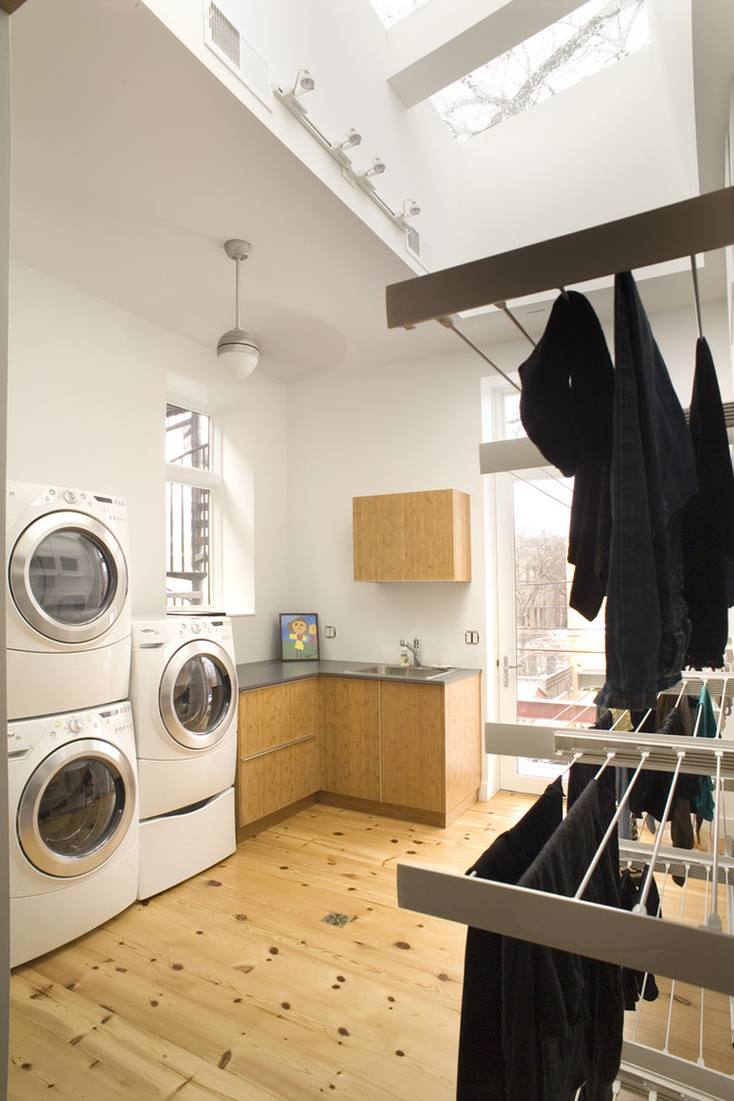 Design ideas for a contemporary laundry room in Chicago with a stacked washer and dryer.