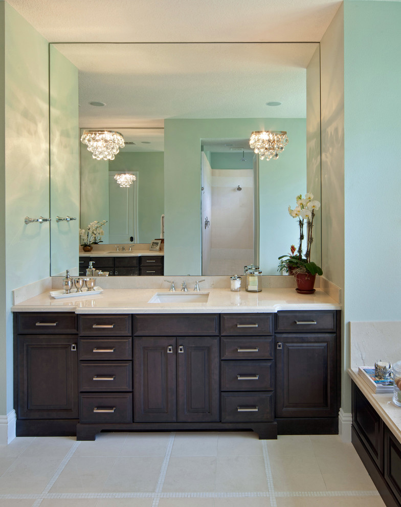 Inspiration for a large traditional master bathroom in Orlando with raised-panel cabinets, dark wood cabinets, an alcove tub, a two-piece toilet, green walls, linoleum floors, an undermount sink, limestone benchtops and beige floor.