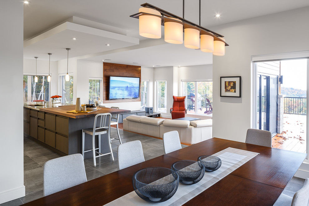 Inspiration for a large contemporary galley eat-in kitchen in Ottawa with an undermount sink, louvered cabinets, white cabinets, wood benchtops, metallic splashback, metal splashback, stainless steel appliances, porcelain floors and with island.