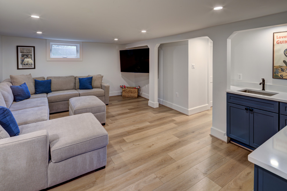 Inspiration for a huge transitional look-out light wood floor and beige floor basement remodel in DC Metro with a home theater and gray walls