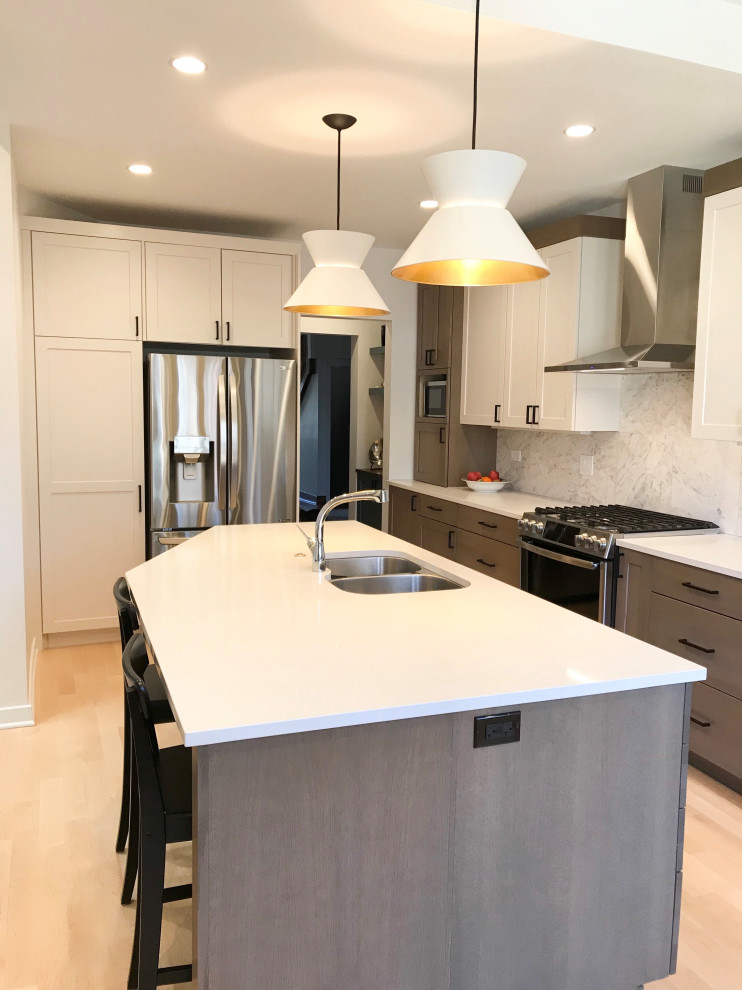 Large transitional l-shaped eat-in kitchen photo in Chicago with a double-bowl sink, shaker cabinets, white cabinets, quartz countertops, multicolored backsplash, porcelain backsplash, stainless steel appliances, an island and white countertops