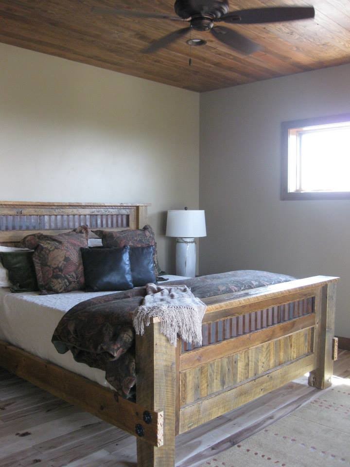 Inspiration for a mid-sized rustic guest light wood floor bedroom remodel with beige walls