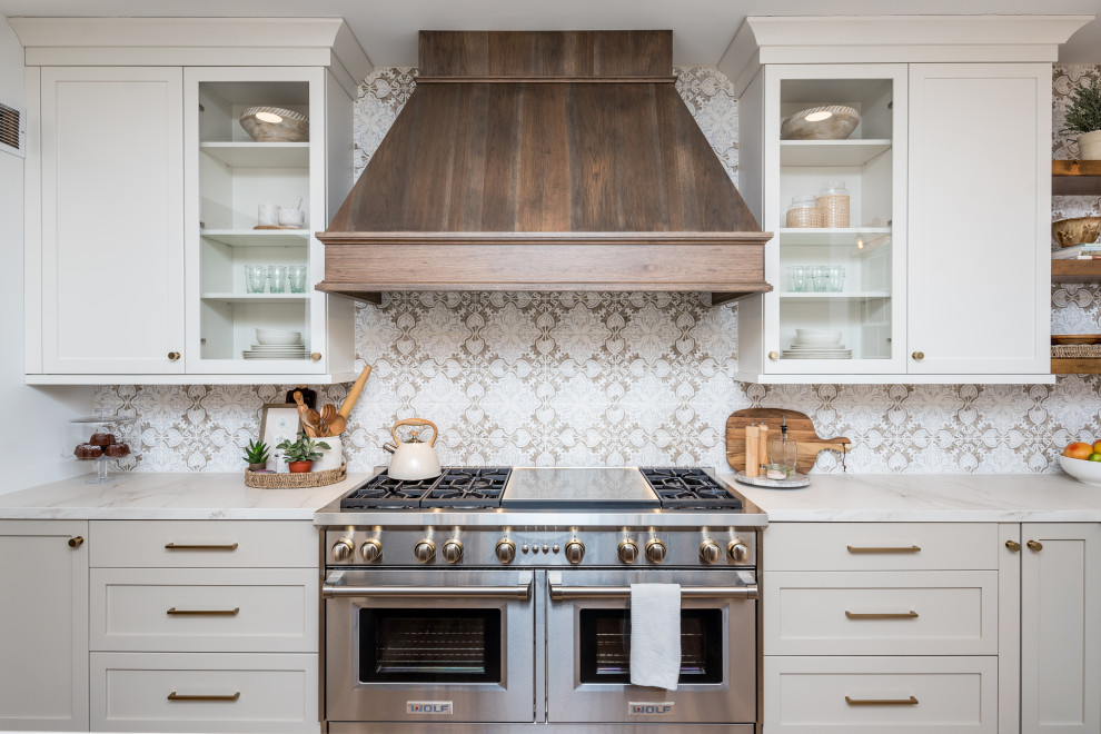 Example of a cottage kitchen design in Philadelphia with flat-panel cabinets, ceramic backsplash and two islands