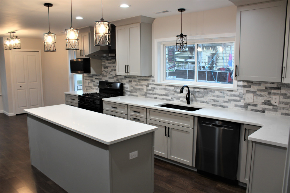 Idéer för att renovera ett stort vintage vit vitt kök, med en enkel diskho, skåp i shakerstil, grå skåp, bänkskiva i kvarts, grått stänkskydd, stänkskydd i stenkakel, rostfria vitvaror, mörkt trägolv, en köksö och brunt golv