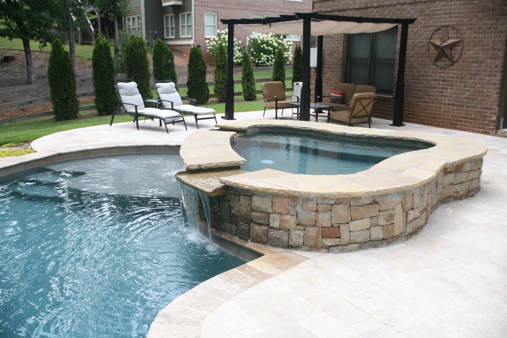 Inspiration for a mid-sized contemporary backyard custom-shaped natural pool in Other with a hot tub and natural stone pavers.