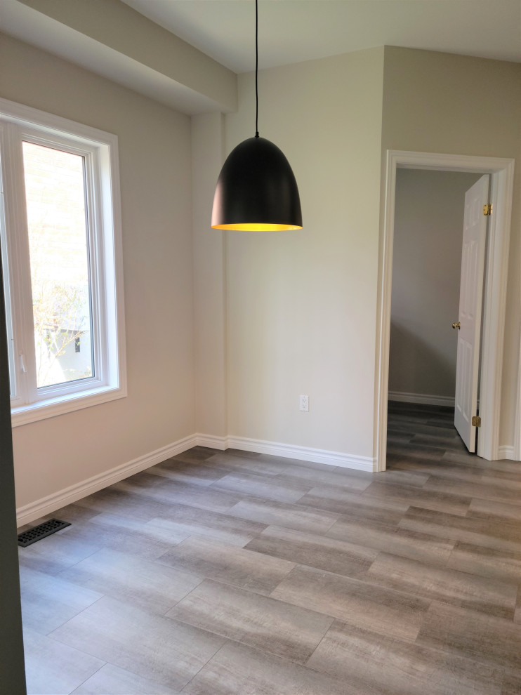 Inspiration for a mid-sized transitional u-shaped vinyl floor eat-in kitchen remodel with an undermount sink, recessed-panel cabinets, blue cabinets, quartzite countertops, white backsplash, porcelain backsplash, black appliances, a peninsula and black countertops
