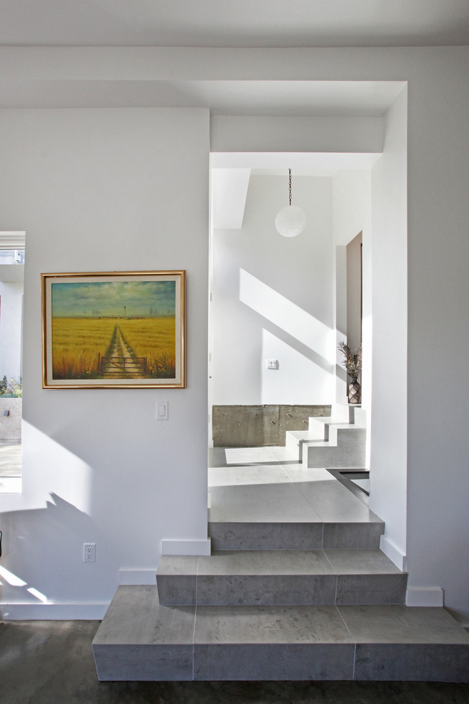 Modern tile l-shaped staircase in Orange County with tile risers.