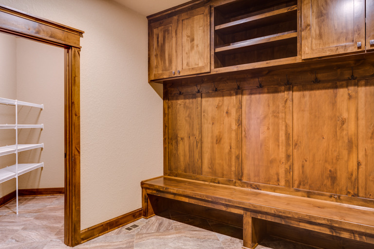 Mountain style mudroom photo with beige walls