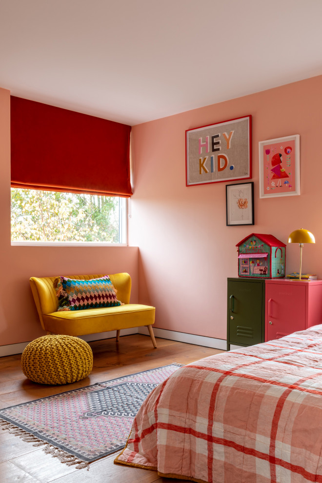 Design ideas for a mid-sized contemporary kids' room in London with pink walls, light hardwood floors and wallpaper.