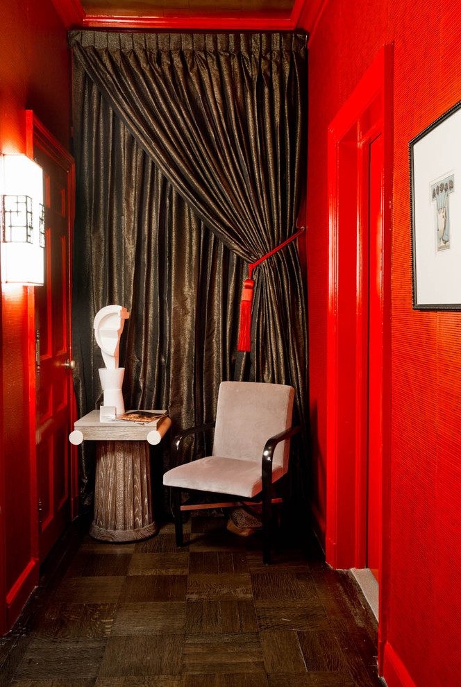 Inspiration for an eclectic hallway in New York with red walls.