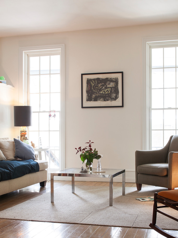 This is an example of a traditional living room in Philadelphia with white walls and medium hardwood floors.
