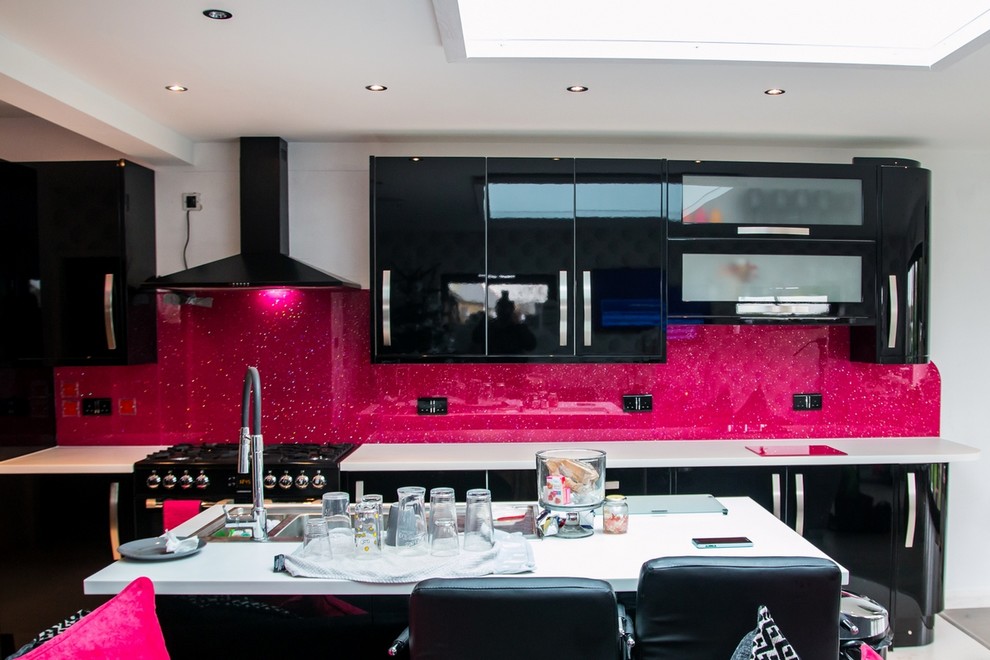Inspiration for a modern kitchen in Hertfordshire with pink splashback and glass sheet splashback.