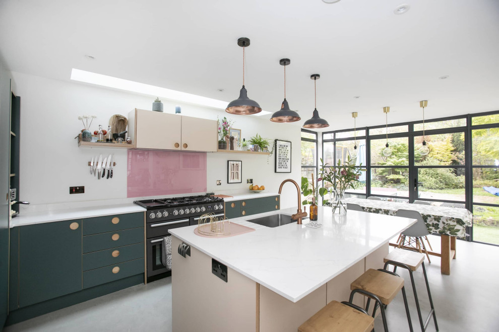 Photo of a small contemporary galley eat-in kitchen in London with an undermount sink, quartzite benchtops, pink splashback, ceramic splashback, black appliances, ceramic floors, with island, grey floor, white benchtop, flat-panel cabinets and green cabinets.