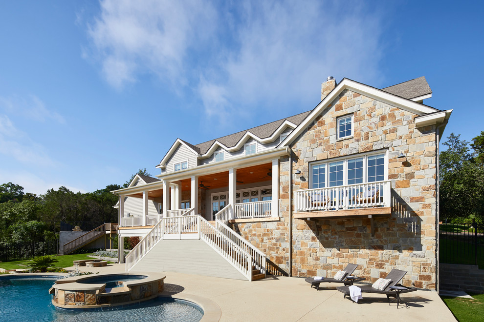 Expansive beach style three-storey beige house exterior in Austin with wood siding, a gable roof and a shingle roof.