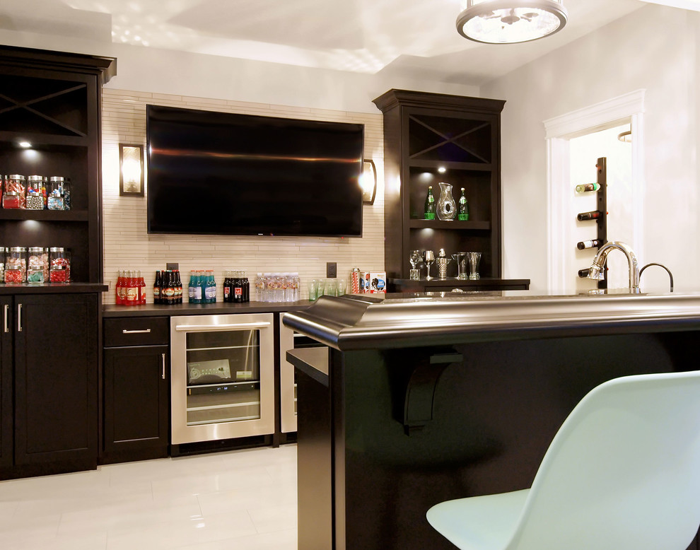 Inspiration for a mid-sized transitional galley seated home bar in Edmonton with a drop-in sink, shaker cabinets, dark wood cabinets, laminate benchtops, beige splashback, ceramic splashback and ceramic floors.