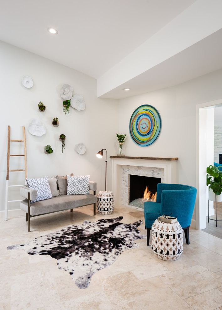 Beach style beige floor living room photo in Los Angeles with gray walls, a standard fireplace and a tile fireplace
