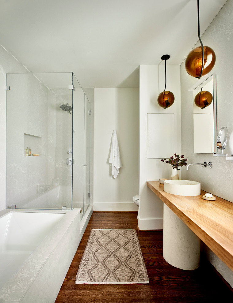 Inspiration for a medium sized contemporary ensuite bathroom in Atlanta with open cabinets, light wood cabinets, a submerged bath, white tiles, stone slabs, white walls, medium hardwood flooring, a pedestal sink, wooden worktops, brown floors, brown worktops, a single sink and a floating vanity unit.