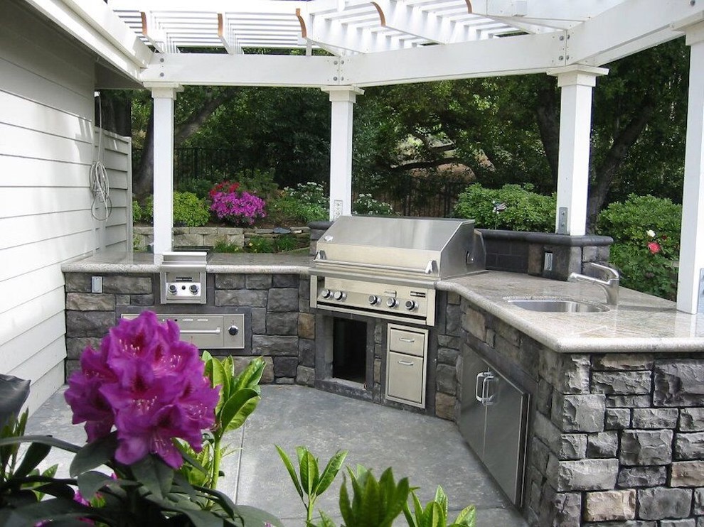 Inspiration for a mid-sized traditional backyard patio in San Francisco with an outdoor kitchen, concrete slab and a pergola.