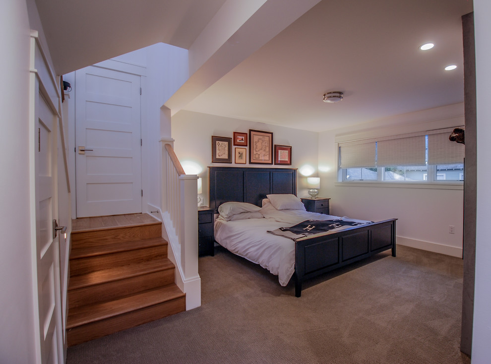 На фото: большая хозяйская спальня в викторианском стиле с белыми стенами, ковровым покрытием, фасадом камина из штукатурки и серым полом с