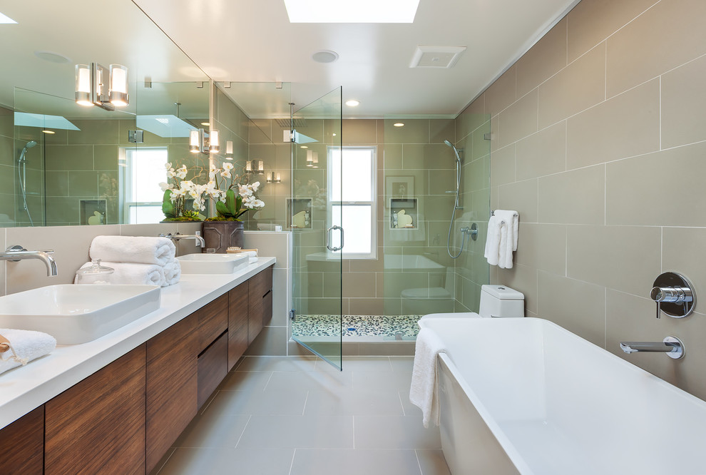 Contemporary master bathroom in Other with a vessel sink, flat-panel cabinets, medium wood cabinets, a freestanding tub, an alcove shower, beige tile, ceramic tile, beige walls and ceramic floors.