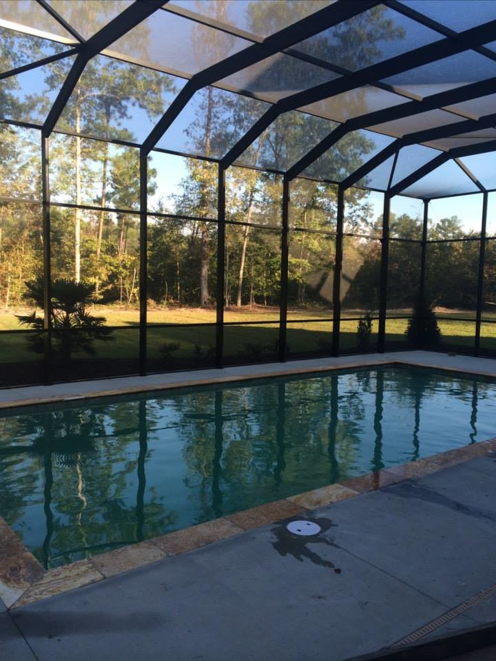 Backyard stamped concrete and rectangular pool photo