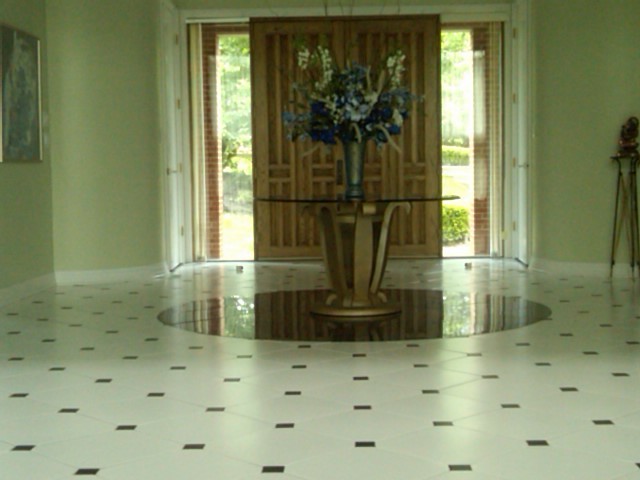 Inspiration for a large transitional porcelain tile foyer remodel with green walls and a medium wood front door