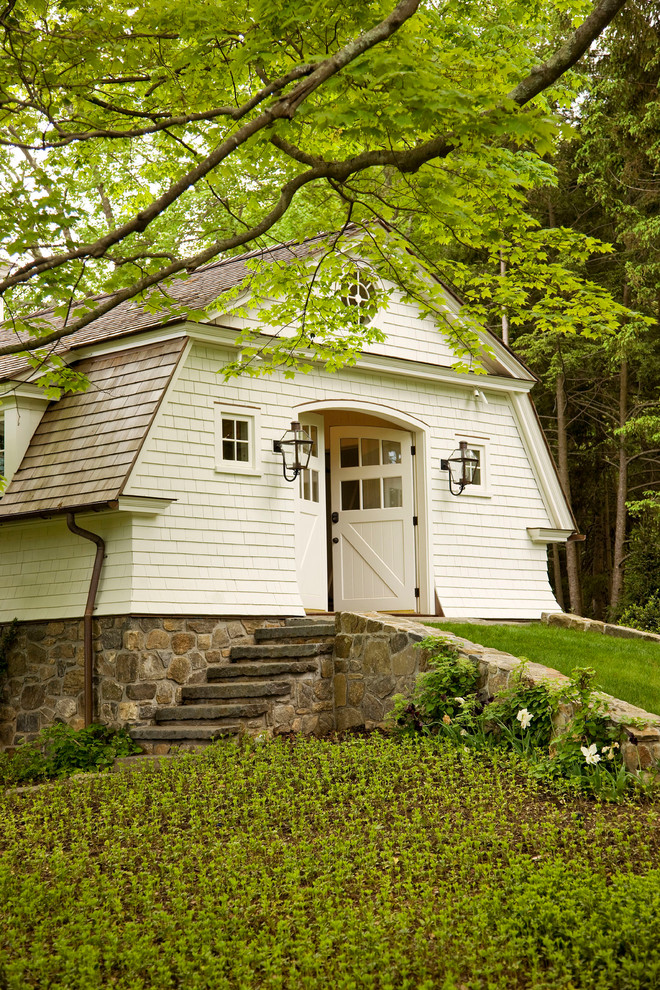 Photo of a large traditional three-storey white exterior in New York with a gambrel roof.