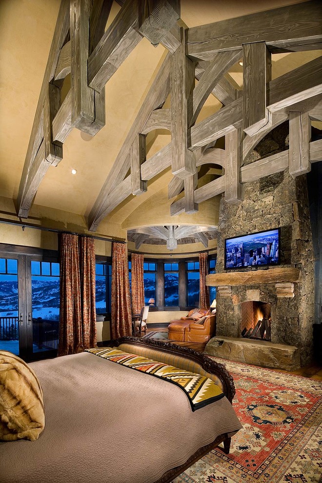 Bedroom - rustic bedroom idea in Baltimore with beige walls, a standard fireplace and a stone fireplace