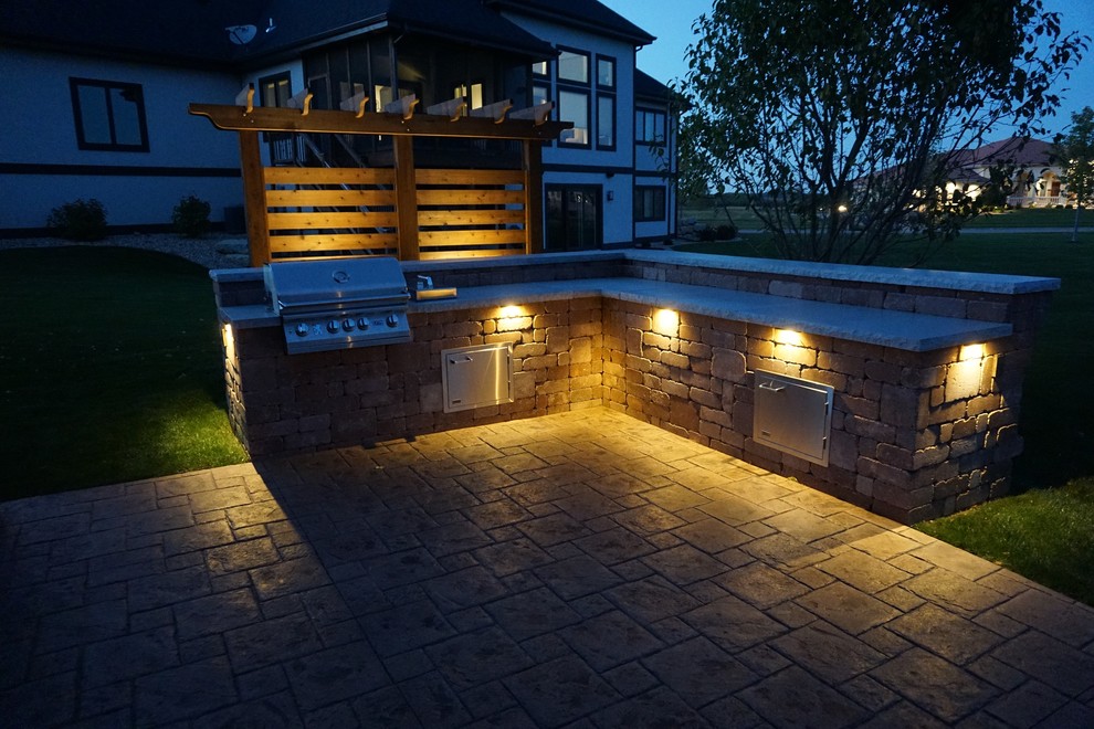 Example of a mid-sized transitional backyard concrete paver patio kitchen design