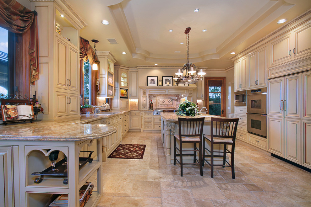 Traditional kitchen in Orange County with raised-panel cabinets, beige cabinets and panelled appliances.
