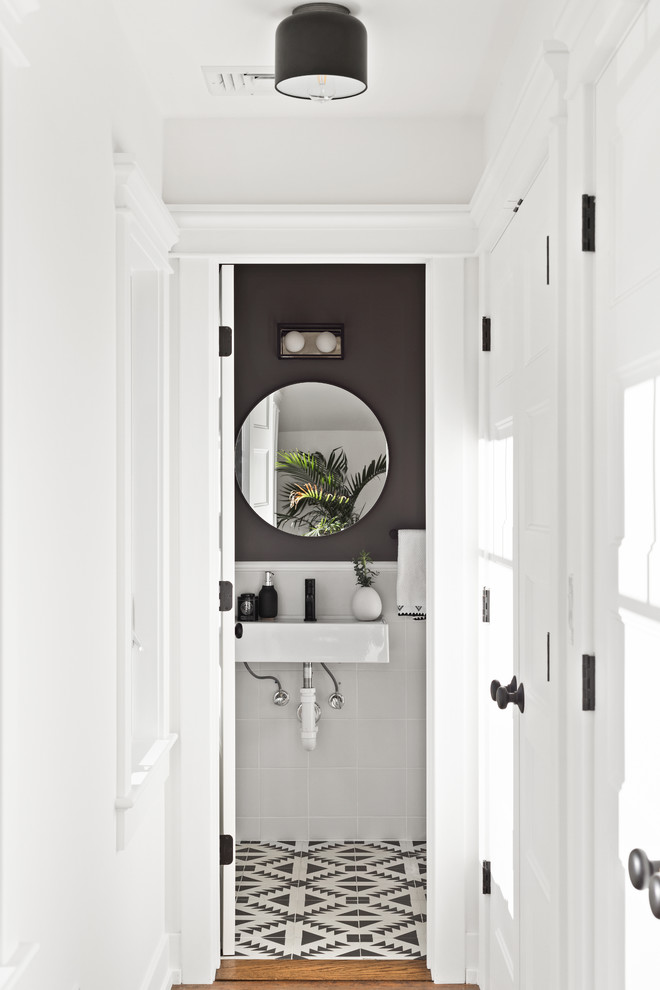 Design ideas for a transitional powder room in New York with white tile, black walls, a wall-mount sink and multi-coloured floor.