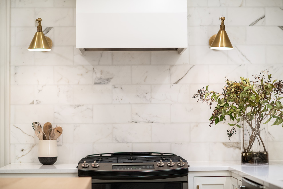 Inspiration for a transitional kitchen remodel in Milwaukee with quartz countertops and marble backsplash