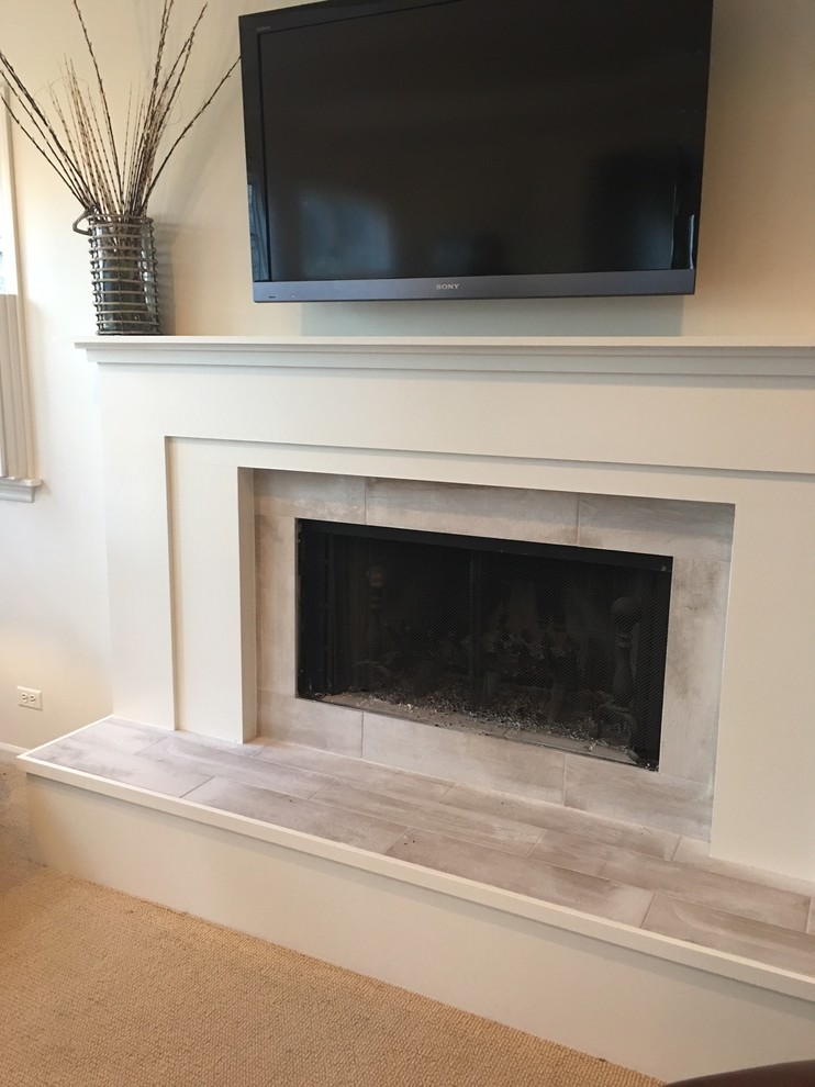 Photo of a mid-sized modern open concept living room in Chicago with white walls, dark hardwood floors, a ribbon fireplace, a tile fireplace surround and brown floor.