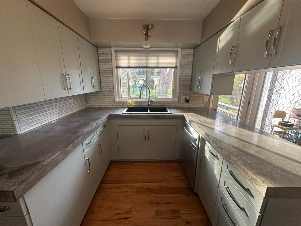 Example of a small transitional enclosed kitchen design with shaker cabinets