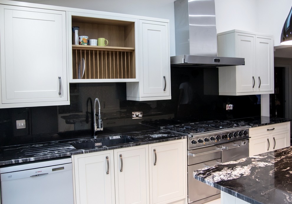 Inspiration for a modern kitchen in Hertfordshire with black splashback and glass sheet splashback.